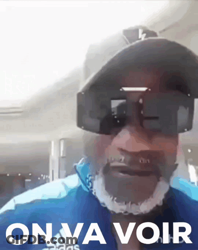 Man In Sunglasses And Hat Saying On Va Voir GIF