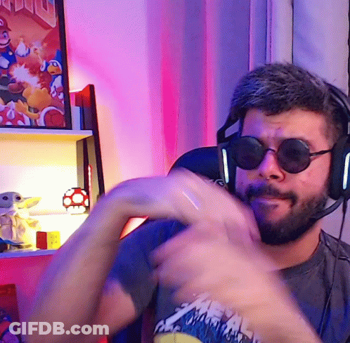 Man In Sunglasses And Headphones In Front Of Mario Poster GIF