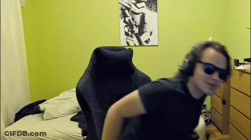 Man In Sunglasses And Headphones Sitting In Bedroom GIF