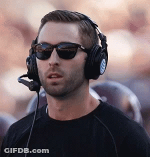 Man In Sunglasses And Headphones With Microphone Standing In Front Of Crowd GIF