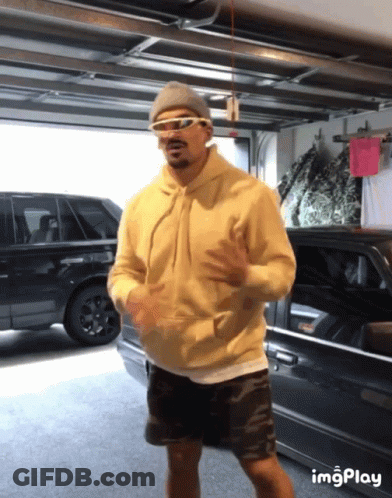 Man In Sunglasses And Hoodie Dancing In Garage GIF