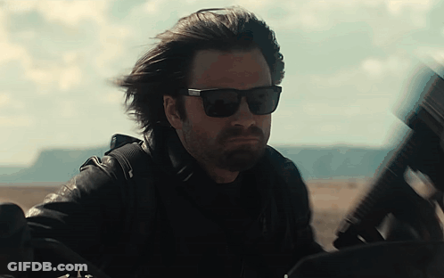 Man In Sunglasses And Leather Jacket Holding Gun GIF