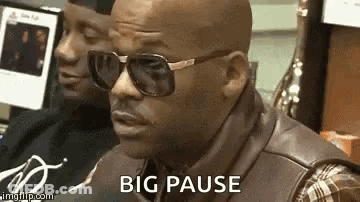 Man In Sunglasses And Leather Vest Sitting At Computer GIF