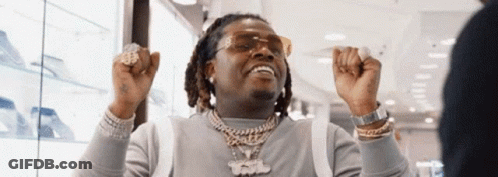 Man In Sunglasses And Necklace Raising Hands In Store GIF