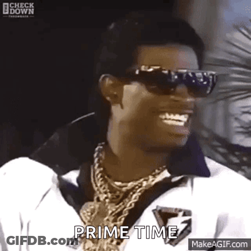 Man In Sunglasses And Necklace Smiling Says Prime Time GIF