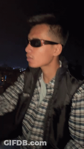 Man In Sunglasses And Plaid Shirt Looking Left GIF