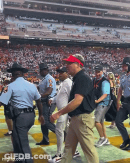 Man In Sunglasses And Red Hat In Front Of Building GIF