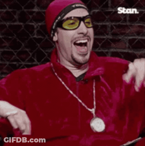 Man In Sunglasses And Red Jacket Laughing With Der War Böse Sign GIF