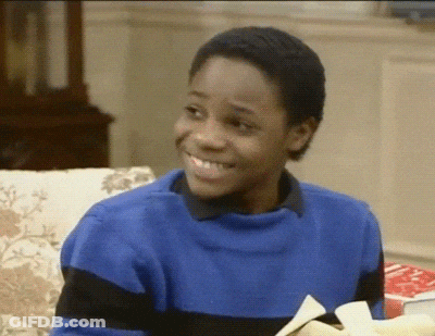 Man In Sunglasses And Red Jacket Making Funny Face On Couch GIF