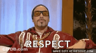 Man In Sunglasses And Red Jacket Sitting Says Respect GIF