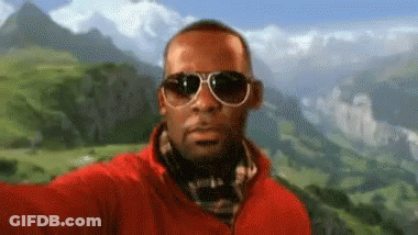 Man In Sunglasses And Red Jacket Taking Selfie With Mountain GIF