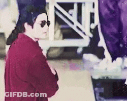 Man In Sunglasses And Red Shirt In Front Of Purple Staircase GIF