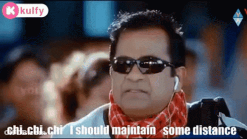 Man In Sunglasses And Scarf Talking About Distance GIF