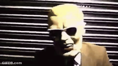 Man In Sunglasses And Suit By Striped Wall GIF