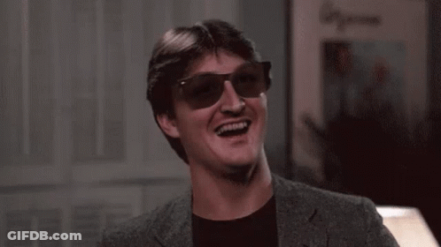 Man In Sunglasses And Suit Laughing And Smiling GIF