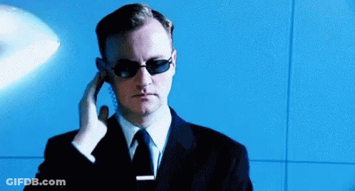 Man In Sunglasses And Suit Talking On Phone GIF