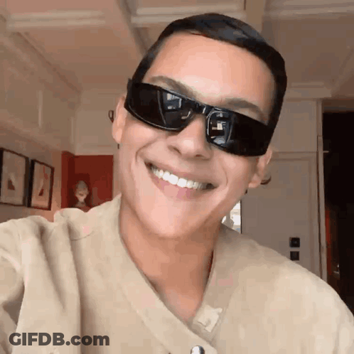 Man In Sunglasses And Tan Shirt Smiling GIF