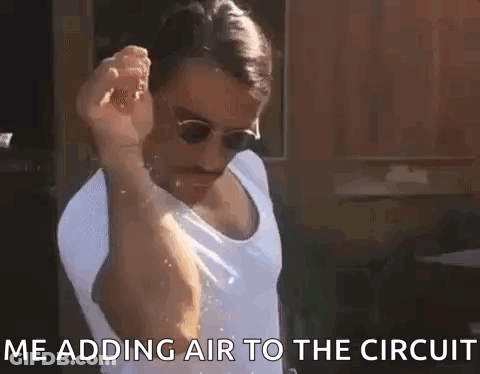 Man In Sunglasses And Tank Top Adding Air To Circuit GIF