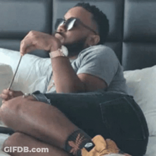 Man In Sunglasses And Watch Sitting On Bed GIF