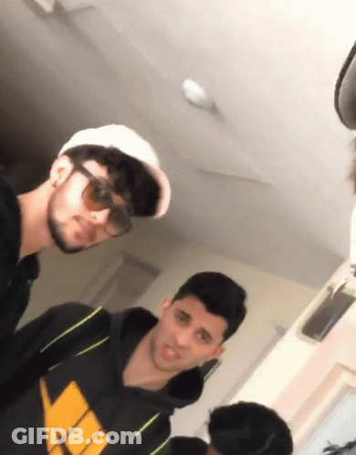 Man In Sunglasses And White Hat Next To Man In Black Hoodie GIF