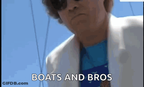 Man In Sunglasses And White Jacket On A Boat GIF