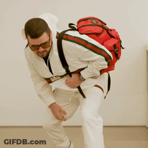 Man In Sunglasses And White Jacket With Red Backpack GIF