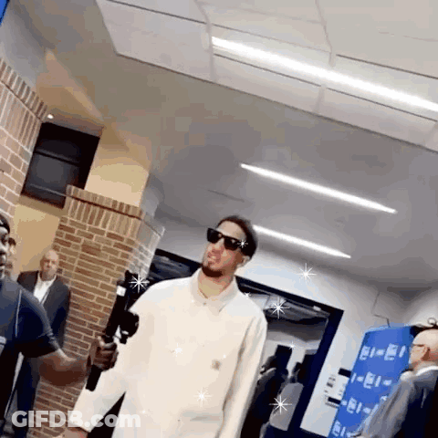 Man In Sunglasses And White Shirt Holding Microphone GIF
