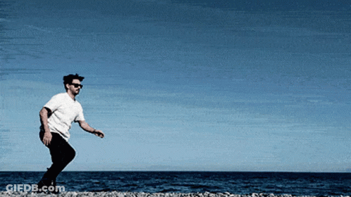 Man In Sunglasses And White Shirt On Beach GIF