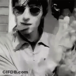 Man In Sunglasses And White Shirt Smoking Cigarette GIF