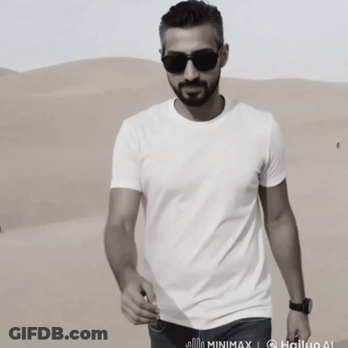 Man In Sunglasses And White T-Shirt Standing In Desert GIF
