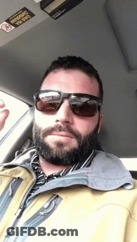 Man In Sunglasses And Yellow Jacket In Car No Smoking Sticker GIF