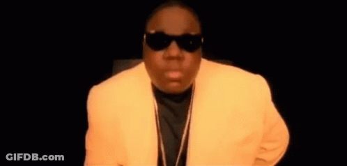 Man In Sunglasses And Yellow Jacket In Dark Room GIF
