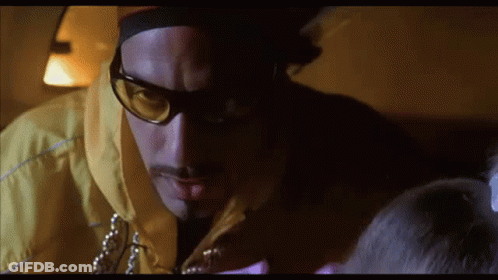 Man In Sunglasses And Yellow Jacket Looking Down GIF