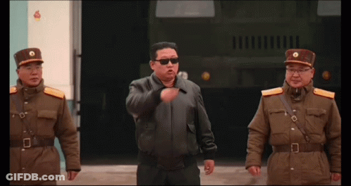 Man In Sunglasses Between Two Uniformed Men GIF