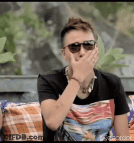 Man In Sunglasses Covering Mouth On Couch GIF