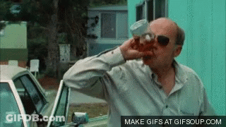 Man In Sunglasses Drinking From Cup Beside Car GIF