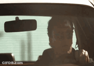 Man In Sunglasses Driving And Looking At Rear View Mirror GIF