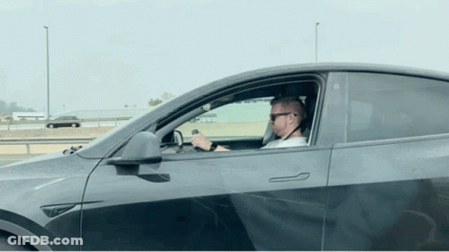 Man In Sunglasses Driving Tesla Model Y GIF