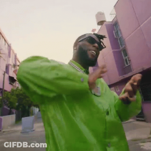 Man In Sunglasses, Green Shirt, Purple Building GIF