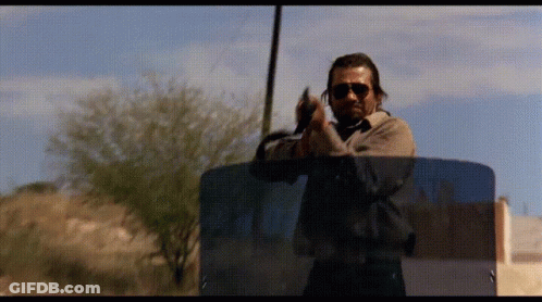 Man In Sunglasses Holding Gun GIF