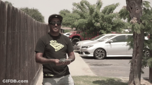 Man In Sunglasses Holding Gun GIF