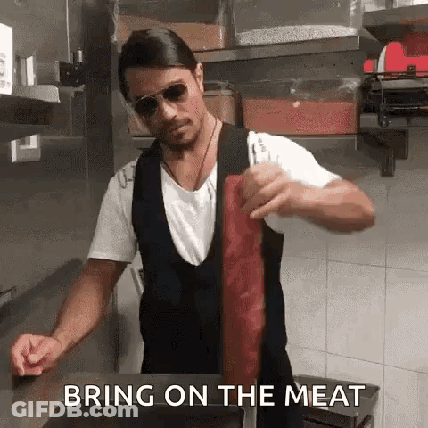 Man In Sunglasses Holding Meat GIF