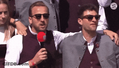Man In Sunglasses Holding Microphone GIF