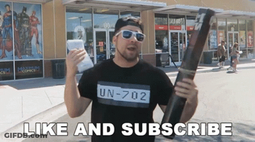 Man In Sunglasses Holding Object In Front Of Store GIF