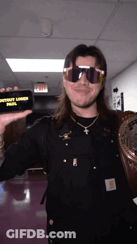 Man In Sunglasses Holding Phone Saying Outout Logan Paul GIF