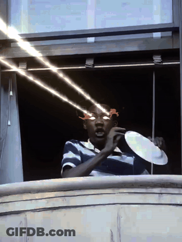 Man In Sunglasses Holding Plate In Front Of Eyes GIF