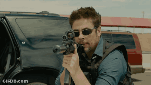 Man In Sunglasses Holding Rifle By Car With LT GIF