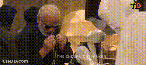 Man In Sunglasses Holding Rosary In Front Of TD Screen GIF