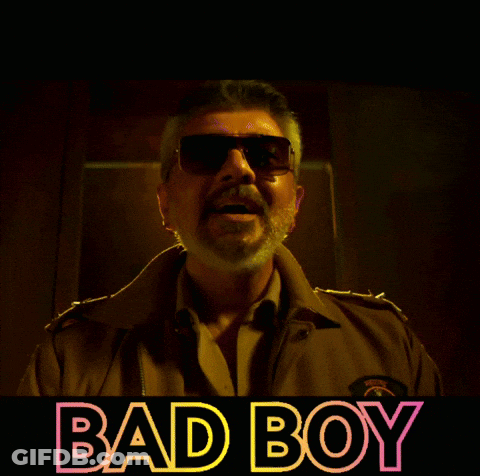 Man In Sunglasses In Front Of Bad Boy Sign GIF