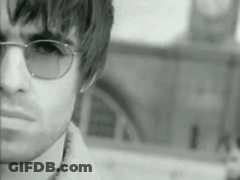 Man In Sunglasses In Front Of Clock Tower Black And White GIF